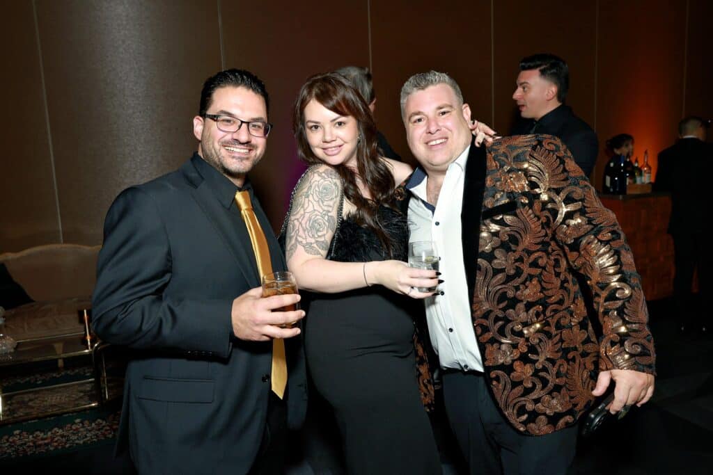 Group of elegantly dressed guests enjoying a luxury event, showcasing stylish attire and drinks, emphasizing the upscale atmosphere of Calgary events.