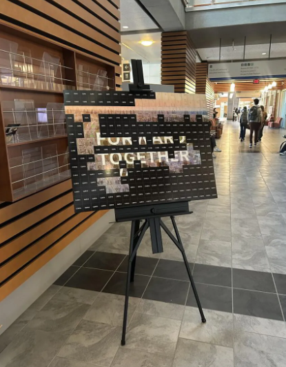 Digital and physical mosaic display featuring the words "FOR AN" and "TOGETHER," created for the ENMAX Leadership Summit at the University of Calgary, showcasing guest participation and collaboration.