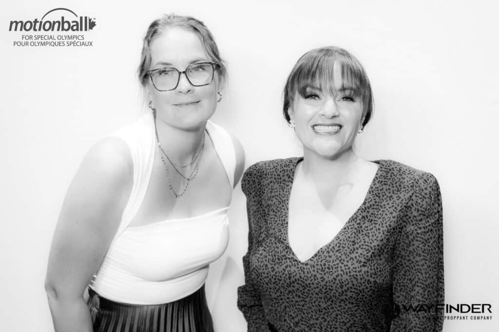 Brittny and Amanda smiling together at a photo booth event, showcasing their friendship and partnership in creating memorable experiences with Cosmo Photo Booths.