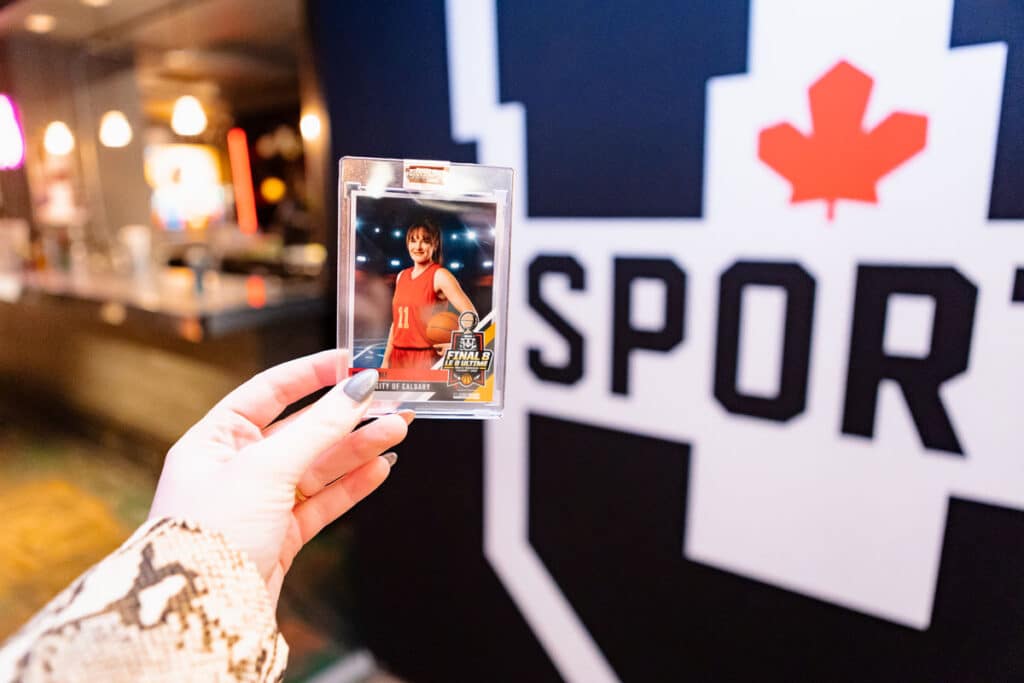 Personalized basketball trading card featuring a player from the University of Calgary, with the U SPORTS logo in the background, showcasing the collectible aspect of the event.
