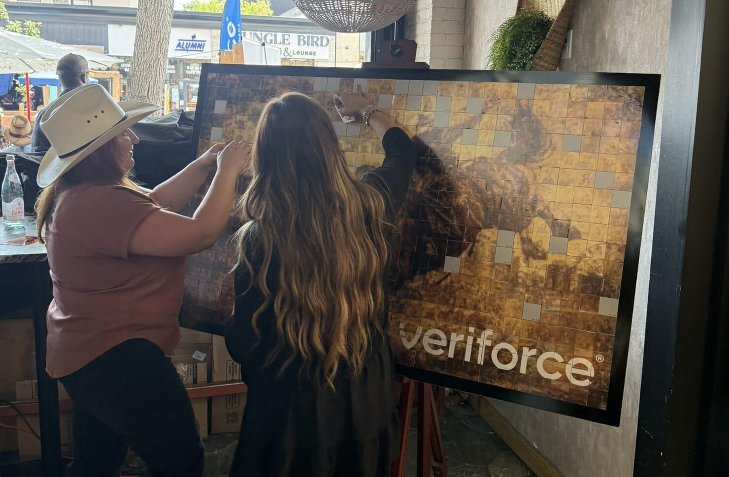 Guests contributing to Veriforce Stampede mosaic artwork, Cosmo Photo Booths interactive experience in Canada.