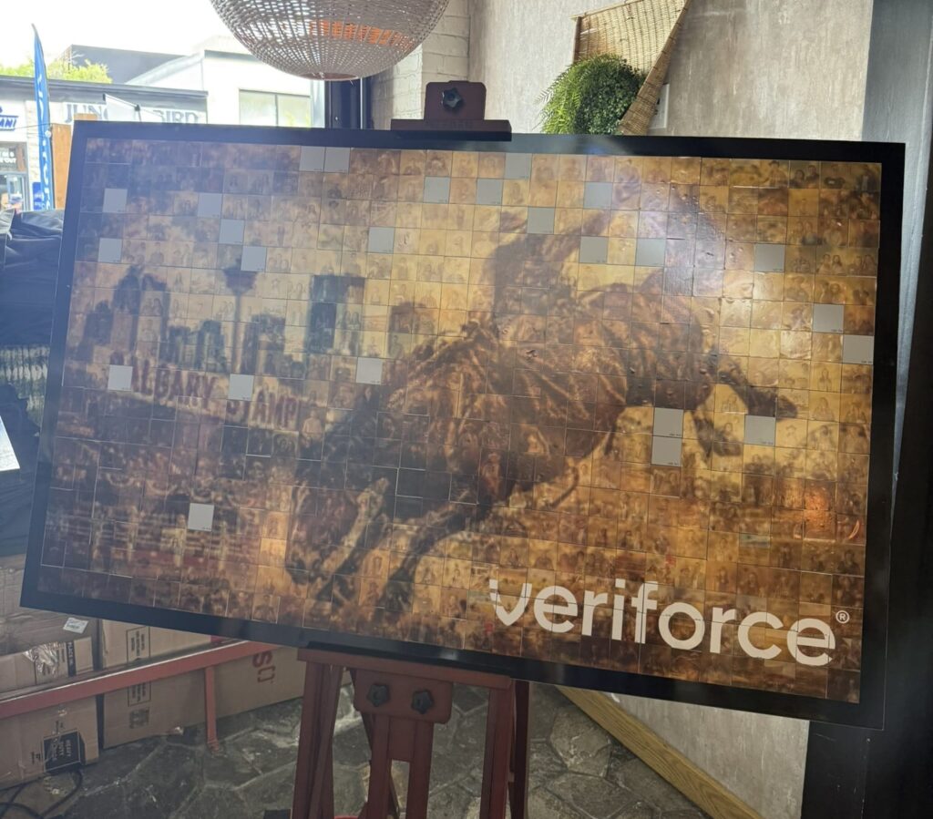 Veriforce Stampede Mosaic Experience photo booth display featuring Calgary skyline and rodeo scene.