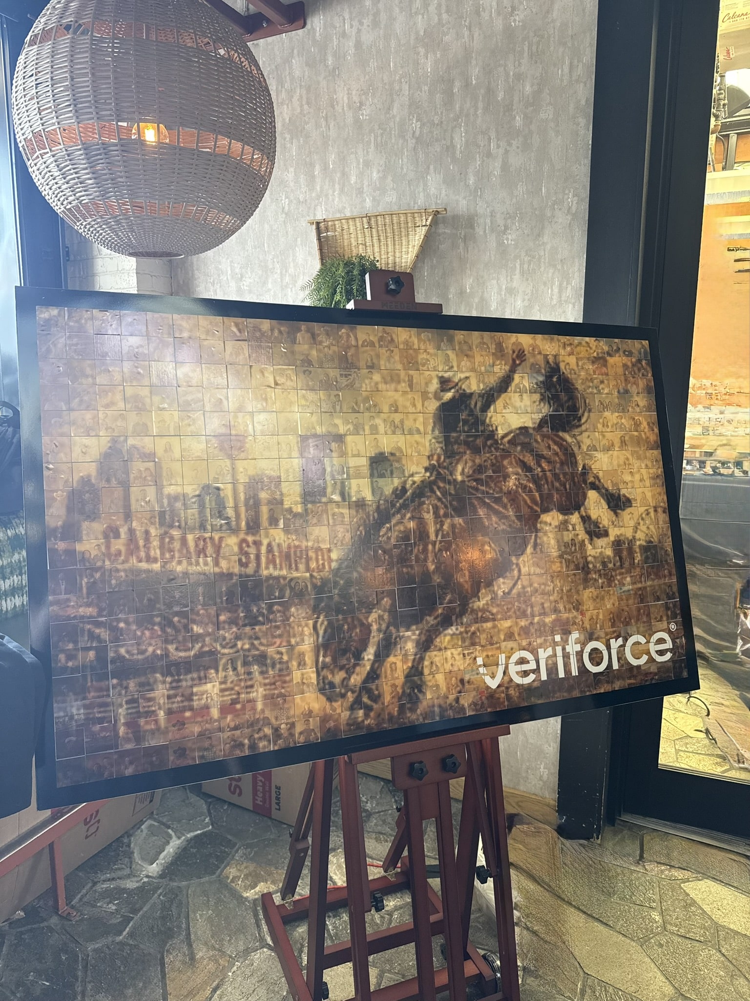 Completed Veriforce Stampede mosaic artwork on display, featuring rodeo rider and branding, a collaborative guest