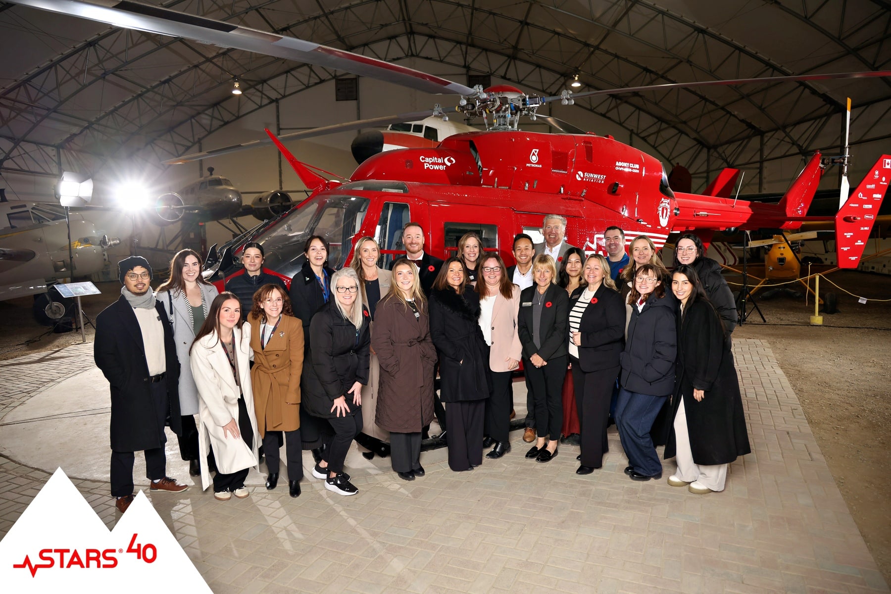 STARS helicopter unveiling event with guests posing for portraits and keepsakes.